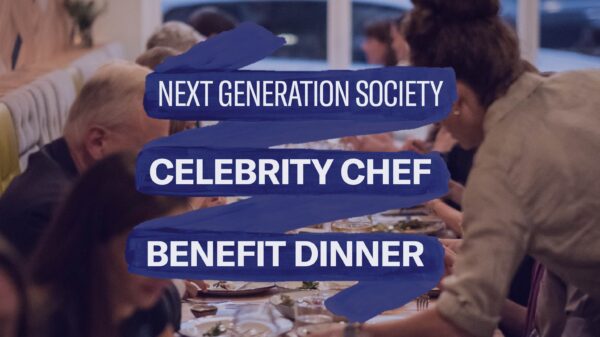 Photo from one end of a table of people sitting and being served food. Navy banner with white text: NEXT GENERATION SOCIETY, (bolded wider text) CELEBRITY CHEF BENEFIT DINNER