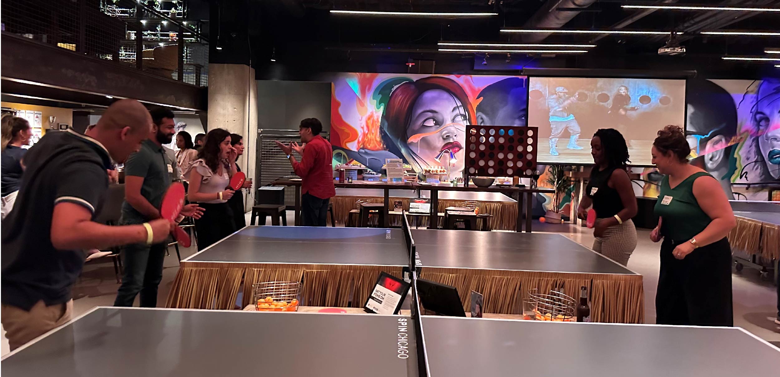 folks playing ping pong at Next Gen happy hour