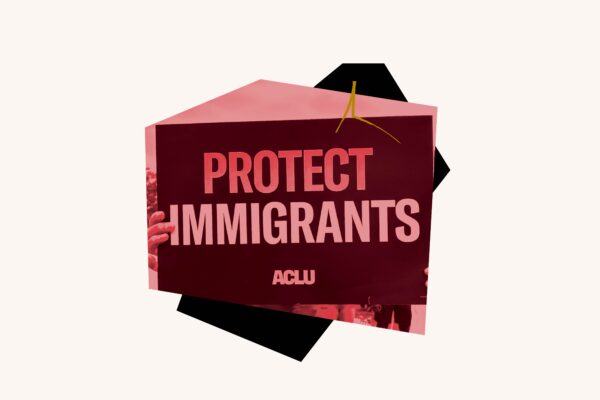 Red filtered image of "Protect Immigrants" sign