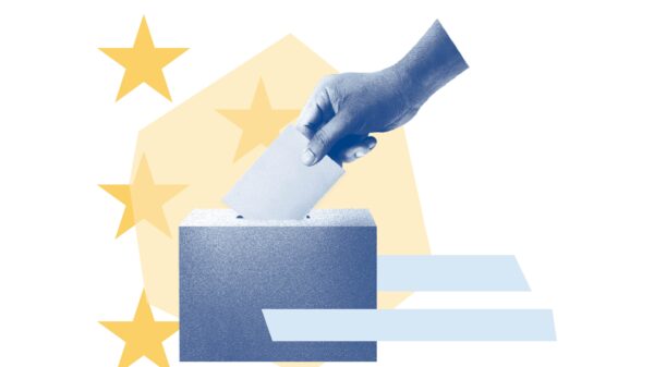 Yellow stars and light blue stripes. Blue filtered hand putting ballot in voting box