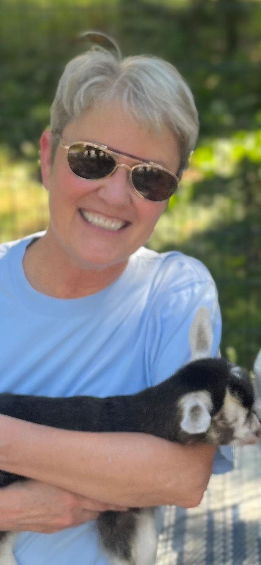 Photo of Heidi Dalenberg holding a baby goat