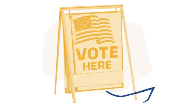 Yellow filtered "vote here" sign