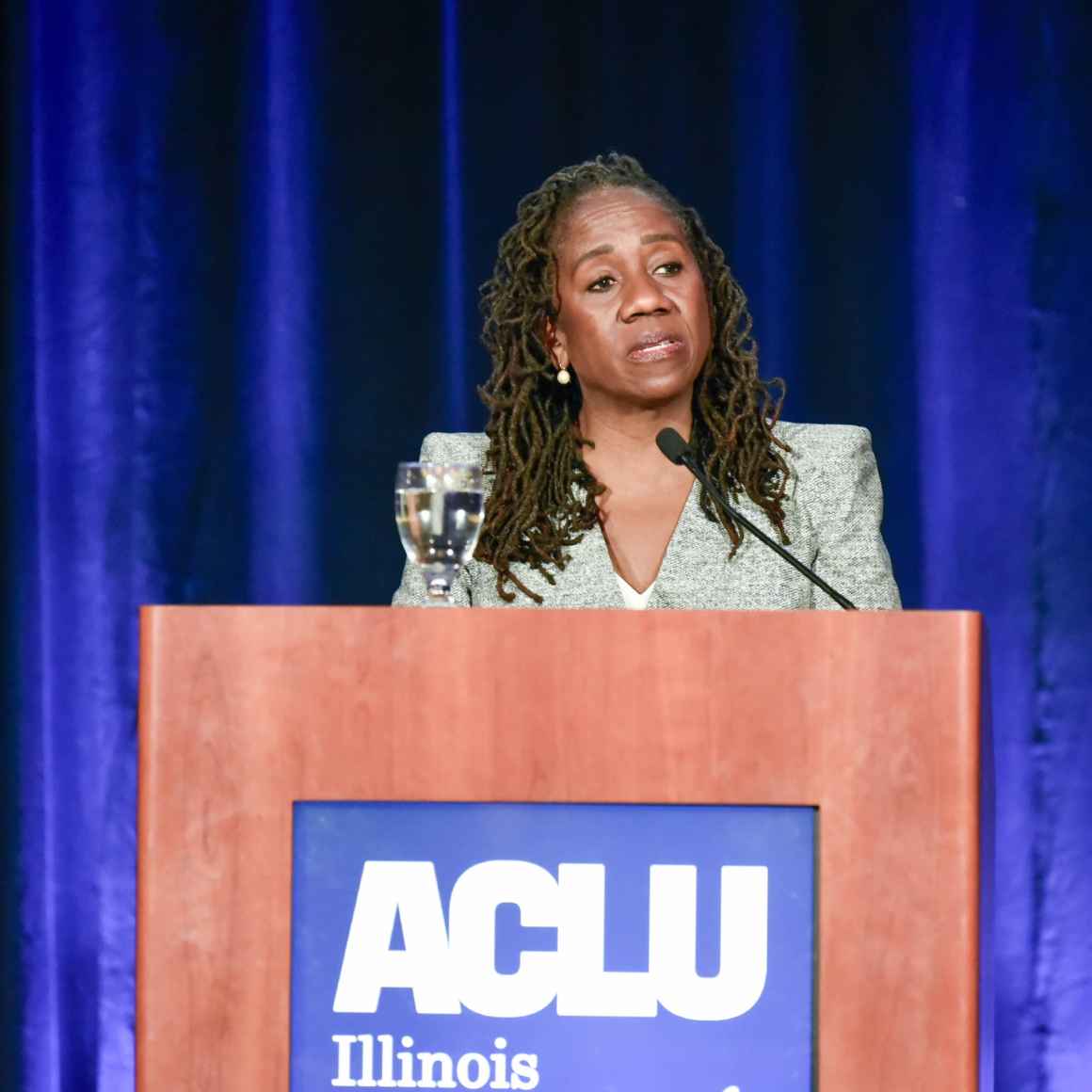Featured Speaker Sherrilyn Ifill standing at the podium to give the keynote speech at the event