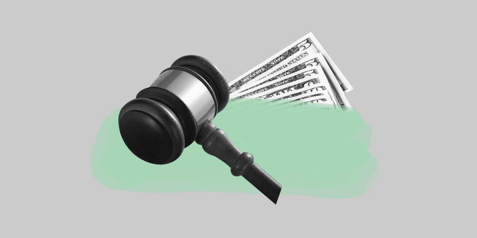 Gray background. Light green paint streak. Behind it a stack of money, in front of it a black and white gavel 